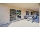 Covered patio featuring outdoor seating, sliding glass doors, and views of the landscaped yard at 15411 W Amelia Dr, Goodyear, AZ 85395
