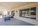 Relaxing covered patio with outdoor seating and views of the landscaped yard with mature trees at 15411 W Amelia Dr, Goodyear, AZ 85395