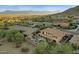 An aerial view of a home with a lush yard, fire pit and a sparkling pool within a beautiful community at 16401 S 29Th Ave, Phoenix, AZ 85045