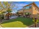 Exterior home view of an expansive yard with a manicured lawn, pool, spa, desert landscaping at 16401 S 29Th Ave, Phoenix, AZ 85045
