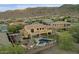 Impressive backyard boasts a pool, spa, built-in barbecue, and a beautifully landscaped yard against a mountain backdrop at 16401 S 29Th Ave, Phoenix, AZ 85045