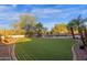 Lush backyard features well manicured landscaping, mature trees, a swimming pool and spa at 16401 S 29Th Ave, Phoenix, AZ 85045