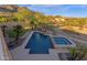 Private backyard retreat features a swimming pool, spa, manicured landscaping, and mountain views at 16401 S 29Th Ave, Phoenix, AZ 85045
