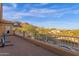 Large balcony overlooks lush landscaping, mature trees, neighboring homes, and distant mountains at 16401 S 29Th Ave, Phoenix, AZ 85045
