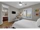 Comfortable bedroom with shuttered windows, soft chair, and access to ensuite bathroom at 16401 S 29Th Ave, Phoenix, AZ 85045