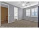 Bedroom featuring carpet flooring, light gray walls, and walk in closet at 16401 S 29Th Ave, Phoenix, AZ 85045