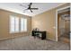Bedroom featuring carpet flooring, tan walls, and bright light filtering window shutters at 16401 S 29Th Ave, Phoenix, AZ 85045