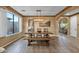 Bright dining room with hardwood floors, bench seating, and large windows at 16401 S 29Th Ave, Phoenix, AZ 85045