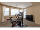 Dedicated exercise room with Peloton bike, treadmill, and natural light creating a private fitness space at 16401 S 29Th Ave, Phoenix, AZ 85045