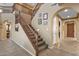 Grand foyer with multi-story staircase, neutral colors, and decorative wall art, creating an inviting entrance at 16401 S 29Th Ave, Phoenix, AZ 85045