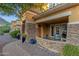 Inviting covered front porch with stone accents and stylish seating at 16401 S 29Th Ave, Phoenix, AZ 85045