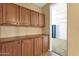 Hallway features custom built-in wooden cabinets for ample storage space at 16401 S 29Th Ave, Phoenix, AZ 85045