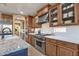 Spacious kitchen with stainless steel appliances, granite countertops, and a custom oven range at 16401 S 29Th Ave, Phoenix, AZ 85045