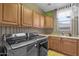 Convenient laundry room with modern washer, dryer, sink, and storage cabinets at 16401 S 29Th Ave, Phoenix, AZ 85045