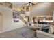 Open living room with a fireplace, adjacent kitchen, and a staircase leading to the second floor at 16401 S 29Th Ave, Phoenix, AZ 85045
