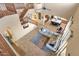 Open concept living room boasts high ceilings, wood staircase, and view into the kitchen at 16401 S 29Th Ave, Phoenix, AZ 85045