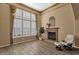 Inviting living room features a cozy fireplace, plantation shutters and great natural light at 16401 S 29Th Ave, Phoenix, AZ 85045