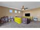 Open concept living room has carpet flooring and a ceiling fan for comfort at 16401 S 29Th Ave, Phoenix, AZ 85045