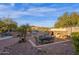 Outdoor kitchen and patio with a grill, built-in cabinets, pizza oven, desert landscaping and a seating area at 16401 S 29Th Ave, Phoenix, AZ 85045