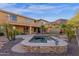 Backyard pool and spa featuring a small water fall, desert landscaping and a partially covered outdoor seating area at 16401 S 29Th Ave, Phoenix, AZ 85045