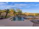 Backyard pool and spa surrounded by desert landscaping and a metal safety fence at 16401 S 29Th Ave, Phoenix, AZ 85045
