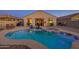 Backyard with a pool, spa, seating, and lighting at 1654 E Jardin Pl, Casa Grande, AZ 85122