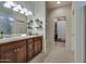 Bathroom with a double sink vanity, updated fixtures, and entry to a walk-in closet at 1654 E Jardin Pl, Casa Grande, AZ 85122