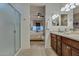 Bathroom featuring a large vanity with cabinetry, updated sink fixtures and a walk-in shower at 1654 E Jardin Pl, Casa Grande, AZ 85122