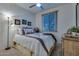 Cozy bedroom featuring a comfortable bed, decorative lamps, and a picturesque window view at 1654 E Jardin Pl, Casa Grande, AZ 85122