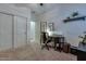 Bright room with a desk and chair beside a closet and shelving unit at 1654 E Jardin Pl, Casa Grande, AZ 85122