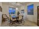 Well-lit dining room features a stylish light fixture and large windows offering pleasant views at 1654 E Jardin Pl, Casa Grande, AZ 85122