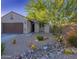 Charming single-story home with desert landscaping, a bench, and a cozy front entrance at 1654 E Jardin Pl, Casa Grande, AZ 85122