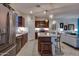 Bright kitchen featuring stainless steel appliances, a large island, and seamless integration with the living space at 1654 E Jardin Pl, Casa Grande, AZ 85122