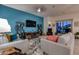Comfortable living room with modern decor, including cozy seating, a large TV, and a stylish rug at 1654 E Jardin Pl, Casa Grande, AZ 85122