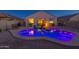 Backyard view showcasing the lit pool, spa and patio with string lights above at 1654 E Jardin Pl, Casa Grande, AZ 85122