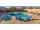 Backyard with a pool, spa, and two Adirondack chairs at 1654 E Jardin Pl, Casa Grande, AZ 85122