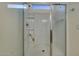 Modern walk-in shower with clear glass door, shelving, and sleek fixtures at 1654 E Jardin Pl, Casa Grande, AZ 85122