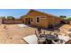 Backyard space featuring a stone path, desert landscaping, and seating area at 16954 W Mohave St, Goodyear, AZ 85338