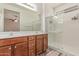 Bathroom with double vanity, shower with glass door and neutral colored walls at 16954 W Mohave St, Goodyear, AZ 85338