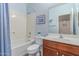Bathroom with bathtub-shower combination, and a cherry wood vanity at 16954 W Mohave St, Goodyear, AZ 85338