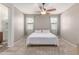 Bright bedroom featuring neutral walls, carpeted floors, and a ceiling fan for added comfort at 16954 W Mohave St, Goodyear, AZ 85338