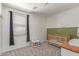 Bedroom with wood accent and a crib with neutral decor at 16954 W Mohave St, Goodyear, AZ 85338