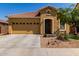 Inviting single-story home featuring a two-car garage and desert landscaping in front at 16954 W Mohave St, Goodyear, AZ 85338