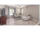 Comfortable living room featuring a neutral color palette and wood-look floors at 16954 W Mohave St, Goodyear, AZ 85338