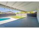 Relaxing covered back patio featuring string lights and a view of the pool and backyard at 1720 W Behrend Dr, Phoenix, AZ 85027