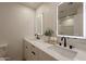 Modern bathroom featuring dual vanities with illuminated mirrors and matte black fixtures offering elegance and functionality at 1720 W Behrend Dr, Phoenix, AZ 85027