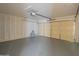 Spacious garage with painted floor and paneled walls at 1720 W Behrend Dr, Phoenix, AZ 85027