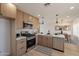 Updated kitchen features stainless steel appliances and stylish cabinets with neutral backsplash at 1720 W Behrend Dr, Phoenix, AZ 85027