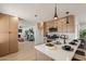 Modern kitchen featuring light wood cabinets, stainless appliances, quartz countertops and an island at 1720 W Behrend Dr, Phoenix, AZ 85027