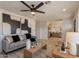Open living room with a modern color palette, comfortable seating, and an open layout with views of the kitchen at 1720 W Behrend Dr, Phoenix, AZ 85027